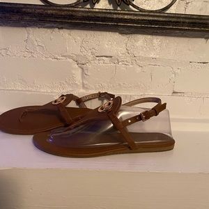 Michael Kors Size 8 Brown. Good  condition but has a scuff on the right sandal.